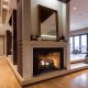 Floor-to-ceiling fireplace walls combine industrial materials, clean lines, and modern interior architecture to create timeless living spaces.